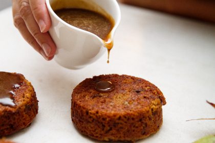 Warm whiskey sauce with cherry date cake.