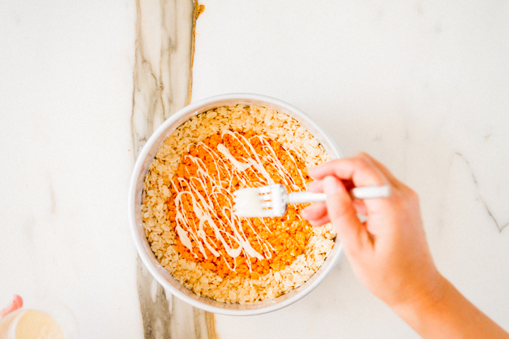 rice krispie pie treat drizzled with white chocolate